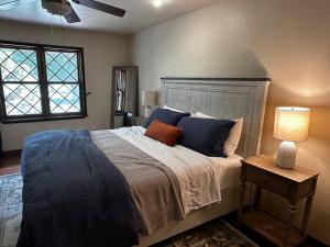 a bedroom with a large bed with blue pillows at Beautiful Farm Home near NMSU in Las Cruces