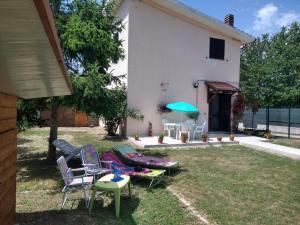 a group of chairs and an umbrella in a yard at Nonna Lella House in Castel di Sangro