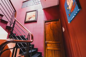 a staircase with a wooden door in a room at The Time Machine in Ho Chi Minh City