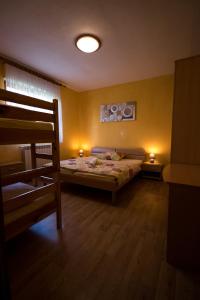 a bedroom with a bed and a bunk bed at Apartment and Room Natasa in Kobarid