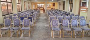a row of chairs in a room with purple seats at The Glacier Hotel Nanyuki in Nanyuki