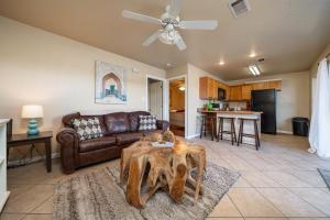 a living room with a couch and a table at Ember’s View, Spa City Jewel- Lovely Lake Condo in Hot Springs