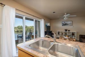 a kitchen with a sink and a large window at Ember’s View, Spa City Jewel- Lovely Lake Condo in Hot Springs