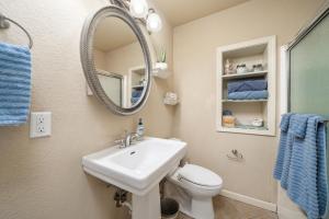 a bathroom with a sink and a toilet and a mirror at Ember’s View, Spa City Jewel- Lovely Lake Condo in Hot Springs +14 photos