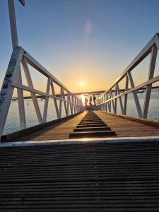 a bridge over the water with two people standing on it at Sleep and Fly in Faro