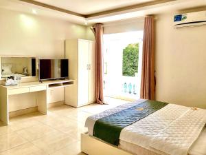 a bedroom with a bed and a large window at Holiday Hotel 2 in Hai Phong