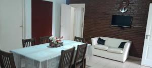 a dining room with a table and a chair at Casa Quinta Corrientes in Corrientes