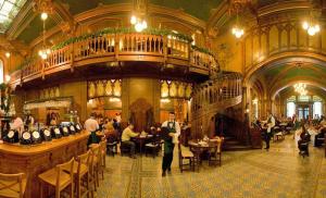 a large room with people sitting at tables in a building at Chic Studio Old City Center - IVO19 in Bucharest