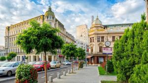 a city street with cars parked on the street at Chic Studio Old City Center - IVO19 in Bucharest
