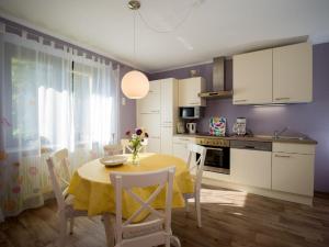 a kitchen with a table with a yellow table cloth at Ferienhaus an der Austwies in Nonnweiler