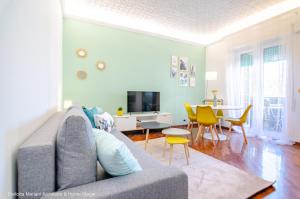 a living room with a couch and a dining room at La Casa di Azzurra in Rome