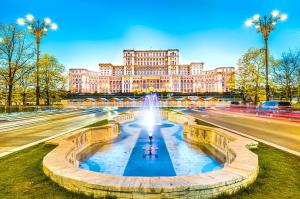 a fountain in front of a large building at Chic Studio Old City Center - IVO19 in Bucharest