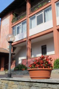 a building with a pot of flowers in front of it at I Due Camini in Baraggia di Boca