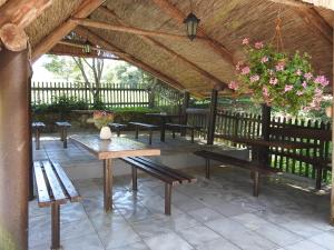 a group of benches sitting under a pavilion at Ubytovanie u Krokodíla in Banská Belá