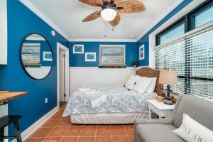 a blue bedroom with a bed and a ceiling fan at Why Knot Getaway…Rooftop with WaterView! Unit F in Beaufort