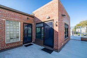 a brick building with two glass doors on it at Why Knot Getaway…Rooftop with WaterView! Unit F in Beaufort