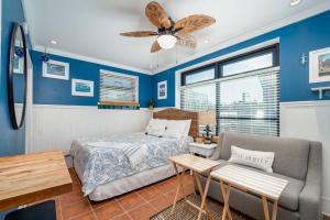 a bedroom with a bed and a couch at Why Knot Getaway…Rooftop with WaterView! Unit F in Beaufort