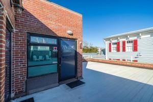 a brick building with a door on the side of it at Why Knot Getaway…Rooftop with WaterView! Unit F in Beaufort