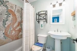 a bathroom with a sink and a toilet at Why Knot Getaway…Rooftop with WaterView! Unit F in Beaufort