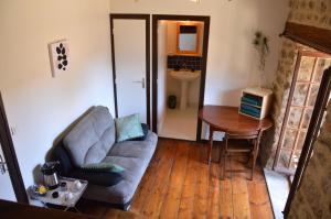 a living room with a couch and a table at Les chambres de Solol in Félines +21 photos