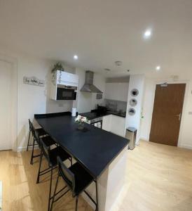 a kitchen with a table and chairs in a room at Comfortable 2 BR Flat TH542 in Basildon