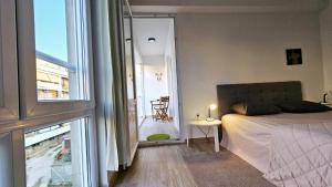 a bedroom with a bed and a view of a balcony at Apartment Rocky II in Zadar