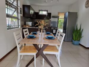 a dining room table and chairs in a kitchen at La Residence Mauritius in Grand-Baie