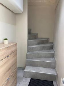 a stairway in a room with a stair case at Studio climatisé proche gare in Bourg-en-Bresse