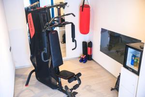 a room with a gym with a video game system at THE SECRET SUITE - SUPERIOR "Lago di Endine" in Ranzanico