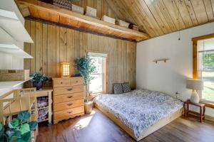 a bedroom with a bed and a wooden wall at Bloomington Home Rental Near Attractions and IU! in Bloomington