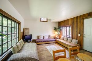 a living room with a couch and a tv at Bloomington Home Rental Near Attractions and IU! in Bloomington