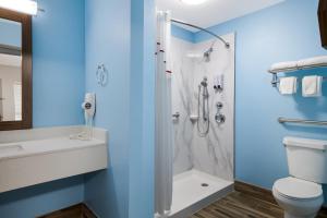 a bathroom with a toilet and a shower at HomeTowne Studios by Red Roof Orange, TX in Orange