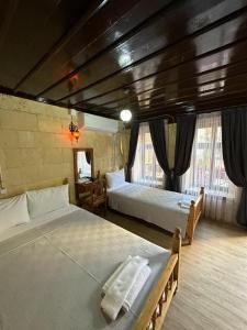 a bedroom with two beds in a room at Hayadlı Konak Butik Otel in Gaziantep
