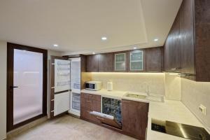 a kitchen with a sink and a microwave at Къща за гости Relax in Hisarya