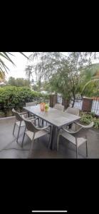 a picnic table with two chairs and a table and a table and chairs at STUDIO IN BONDI in Sydney