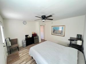 a bedroom with a bed and a ceiling fan at Little Betty's Casita in Torrance