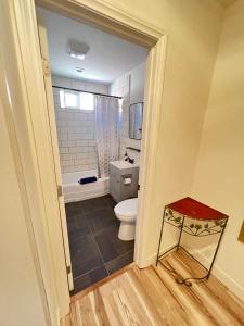 a bathroom with a toilet and a tub at Little Betty's Casita in Torrance