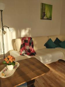 a living room with a couch and a table at Saulriets in Liepāja