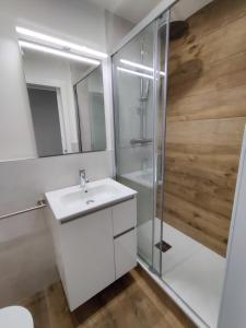 a bathroom with a white sink and a shower at Sereno rincón de montaña in Sant Corneli de Cercs  +36 photos