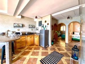 a kitchen with a stainless steel refrigerator in a room at Dar diafa samira surf in Mirleft