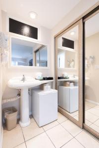 a bathroom with a sink and a mirror at King Frederik Inn in Solvang