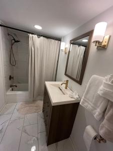 a bathroom with a sink and a shower and a mirror at Modern Athens Home 4bd, 3bth in Athens