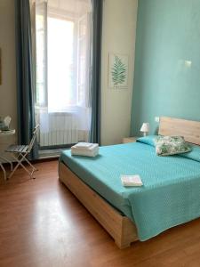 a bedroom with a bed and a window and a chair at B&B Home XIX in Narni