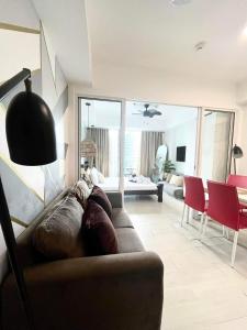 a living room with a couch and a dining room at Azure Urban Beach Resort by Melrose Avenue in Manila