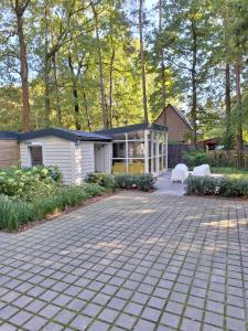 a house with a brick driveway in front of it at Chalet in Ursel in Aalter