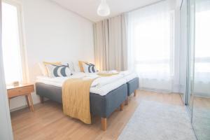 a bedroom with a bed with pillows on it at Rahulihomes Lutakko in Jyväskylä