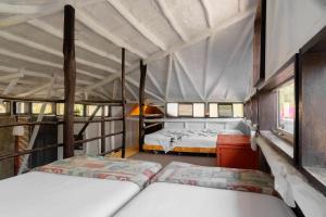 a bedroom with two beds in a tent at Las Cabañas de Tarii in Cieneguilla