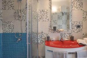 a bathroom with a red sink and a shower at [Burlo Garofalo] Modern Apartment *Wifi+Netflix* in Trieste