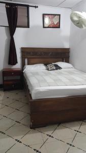 a bed sitting in a room with at HOTEL LA CORDIALIDAD in Barranquilla