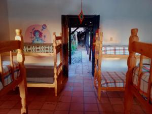 a room with several bunk beds and a hallway at Valizas 1900 in Barra de Valizas